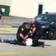 Police are seen violently arresting Richard Hubbard III while his companion looks on and records with a cellphone. (Leshaunda Malone via Facebook)